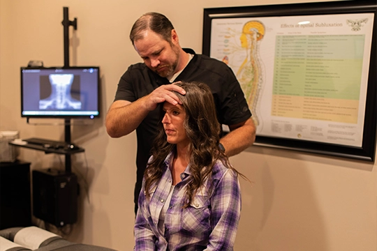 Chiropractor St. George UT Corey Wilhelmsen Examining Patient